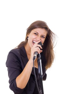 Girl with long hair singing into microphone