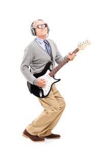 Mature Man Rocking Out with Guitar