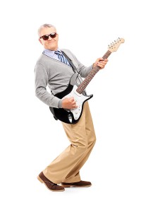 Mature Man Rocking Out with Guitar.