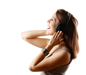 Smiling Girl having singing lessons with headphones.